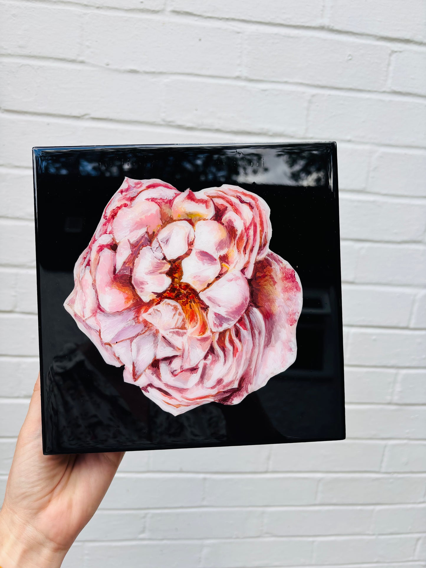 Pink flower on black background with resin coating on panel. Hitchin Letchworth Hertfordshire original art