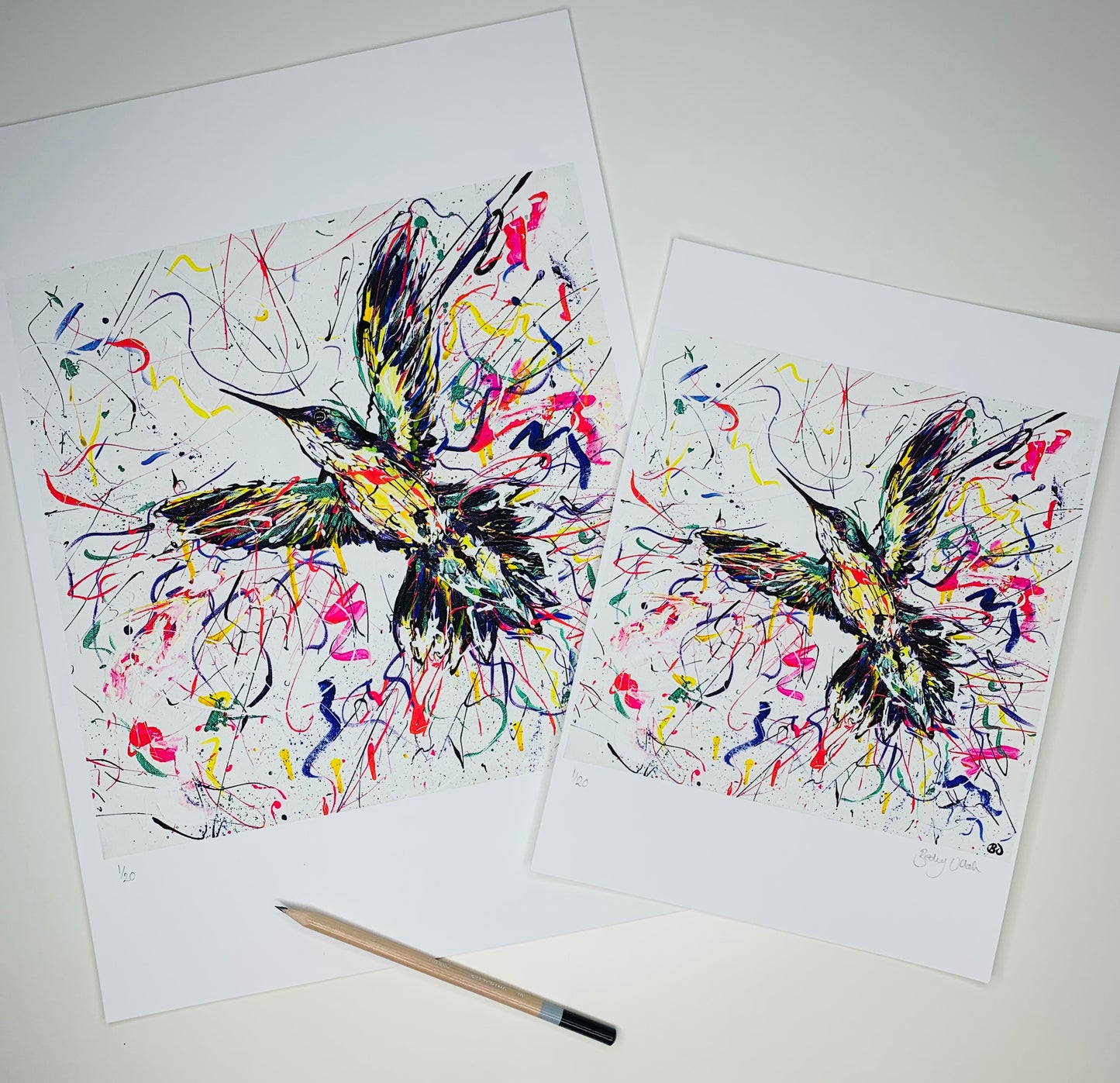 A3 (27.5 x 27.5cm) and A4 (20.5 x20.5cm) prints side by side, slightly overlapping with pencil for size reference