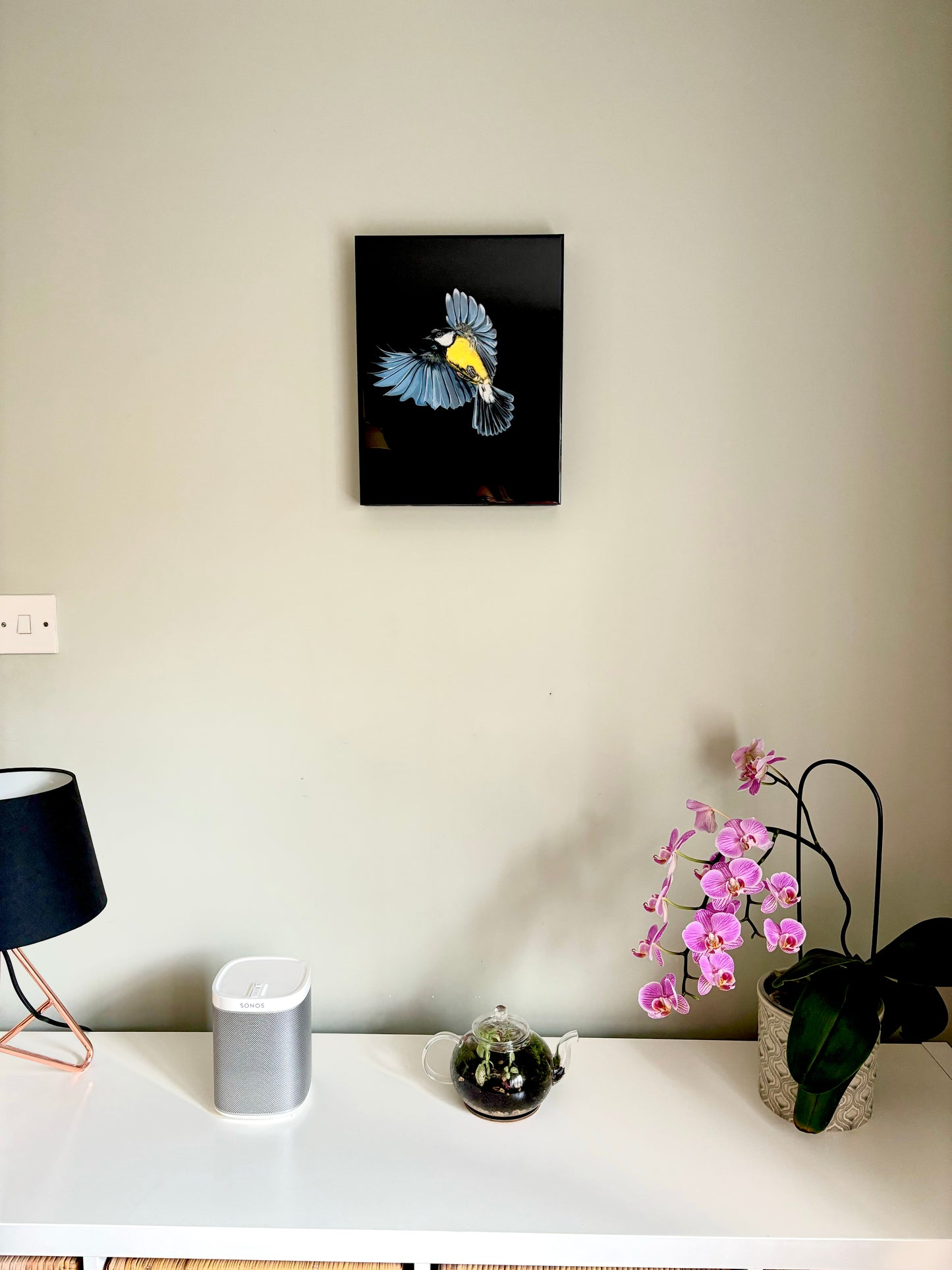 front view in context of resin art of great tit with pink orchid, glass teapot and sonos for size comparison