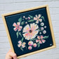 Dark blue mini canvas with soft pink peach florals in pine floater frame. Affordable original art hitchin letchworth hertfordshire