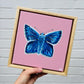 A common blue butterfly with soft white fluffy details painted on a soft pink mini canvas in a wooden floater frame. Hitchin Letchworth Artist. Affordable original art. 