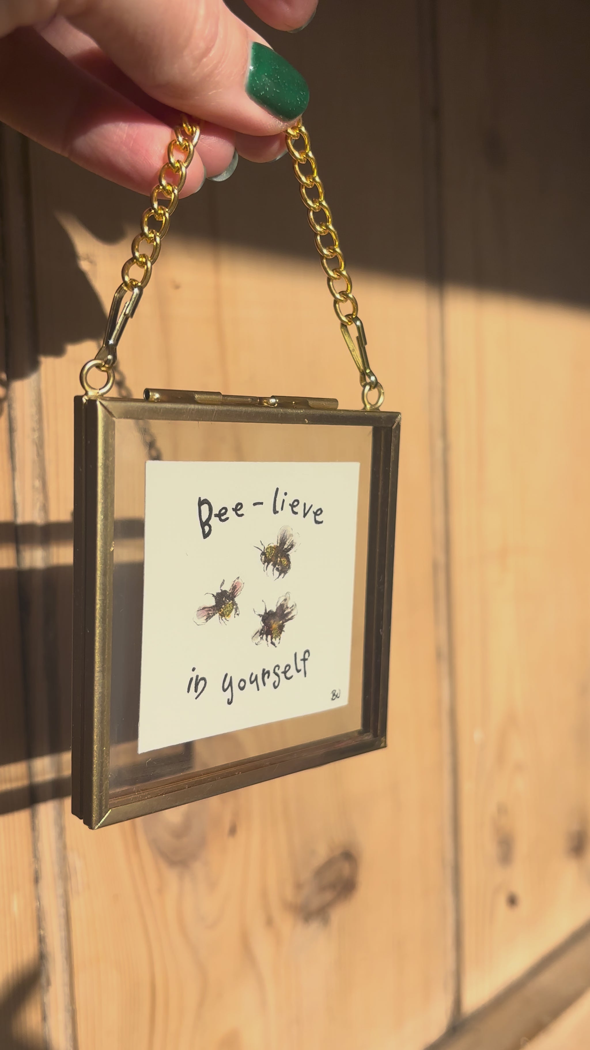 video of bee painting in tiny gold frame