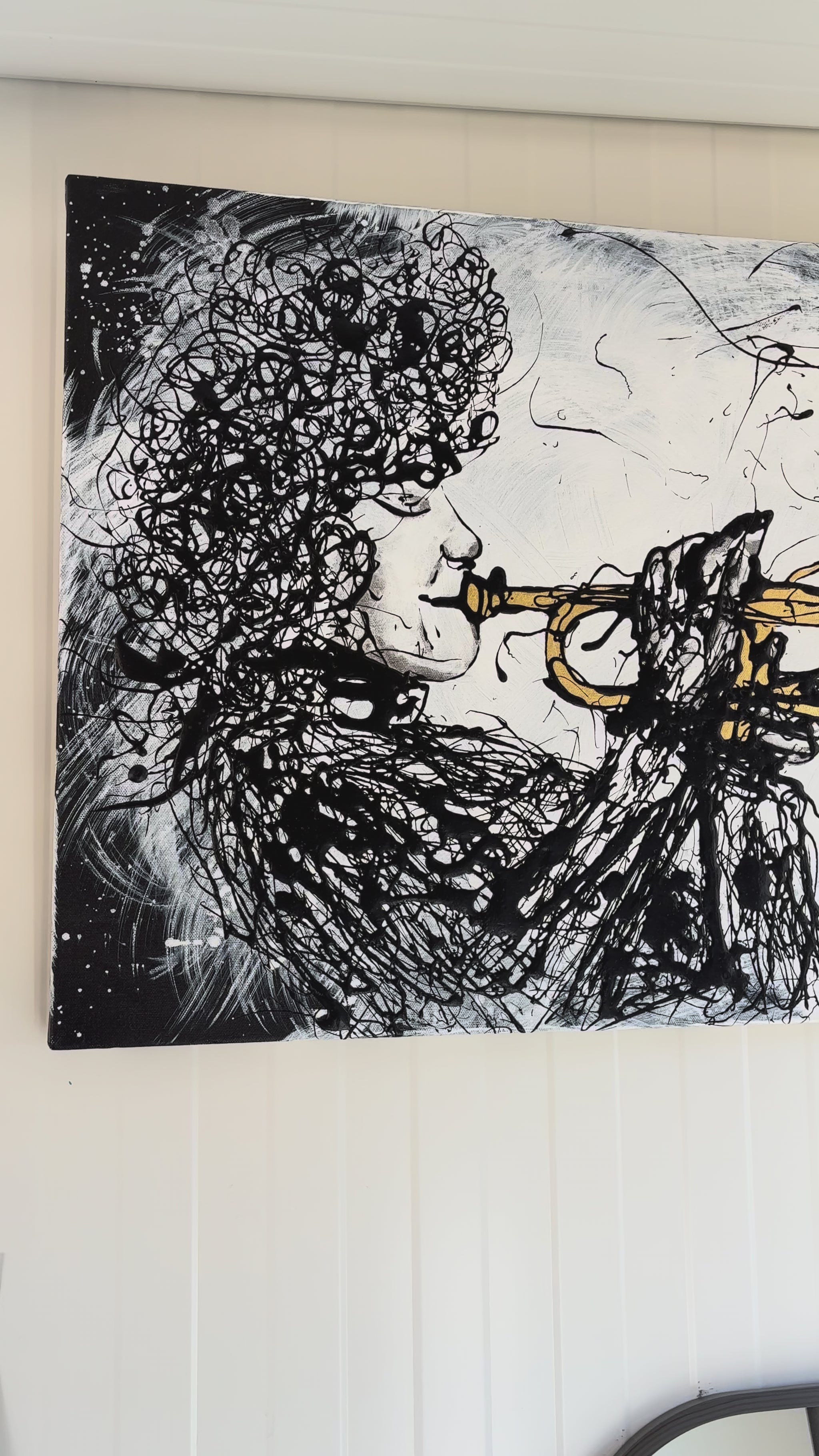 video of drip painting of trumpet player, demonstrating gold-leaf
